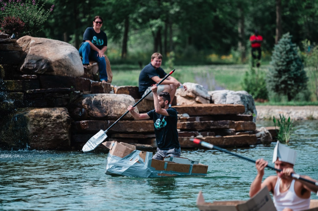 People canoeing by water feature with others waiting nearby during corporate retreat at Retreat 21 near Columbus, Ohio